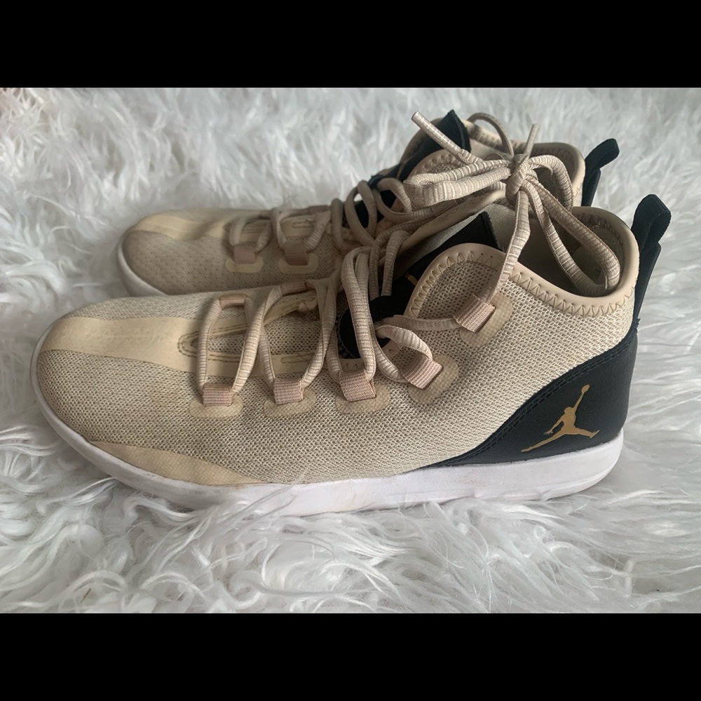 cream and black nike jordan’s